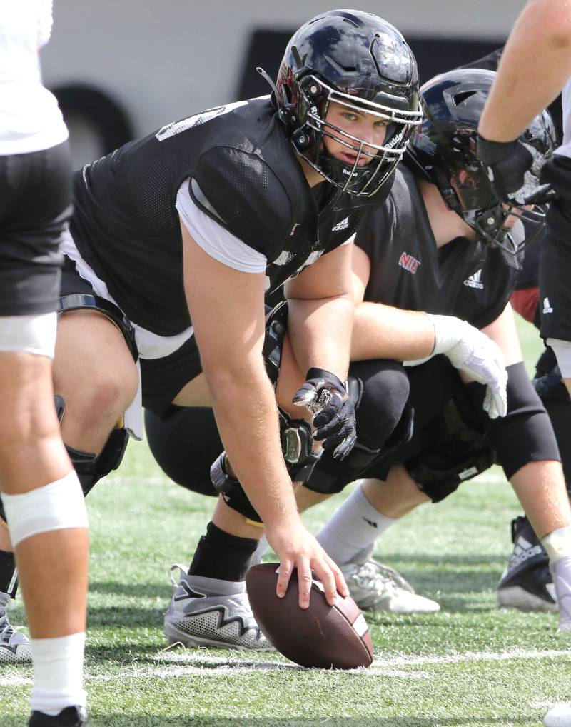 Northern Illinois Huskies center Pete Nygra looks over the defensive formation as he prepares to snap the ball Tuesday, Aug. 9, 2022, during practice in Huskie Stadium at NIU.