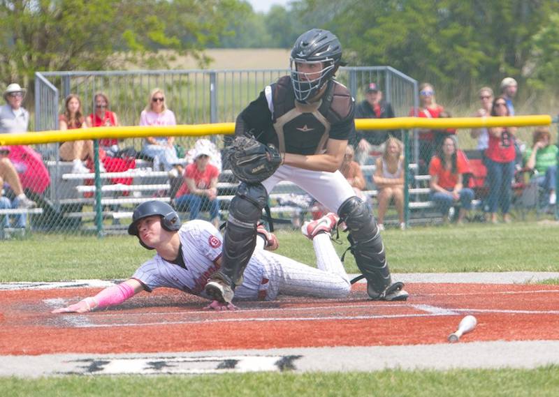 Benet's Nathan Cerocke slides into home plate as the ball goes past Kaneland's Nathan Campbell at the Class 3A Kaneland Regional Final on Saturday, May 31, 2025 in Maple Park.