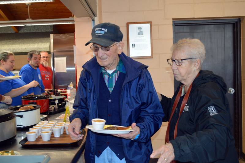 Leatrice Bricksler, right, and Ron Kuntzelnen, both of Leaf River, get food during Leaf River Lion's annual Breakfast with Bunny in the Bertolet Memorial Building on April 16.