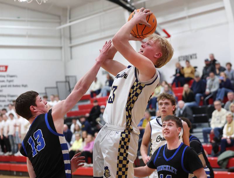 Marquette's Luke McCullough shoots over Hinckley-Big Rock's Jacob Orin Tuesday, March 3, 2026, during their sectional semifinal matchup at Amboy High School.