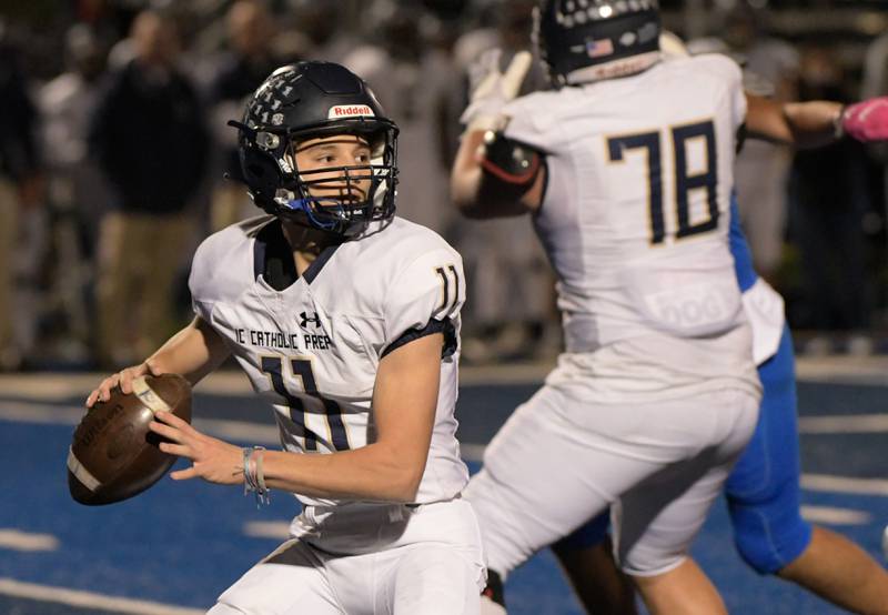 IC Catholic Prep's quarterback Dennis Mandala (11) looks for an open receiver during the fourth quarter against St. Francis in Wheaton on Friday, October 22, 2021.