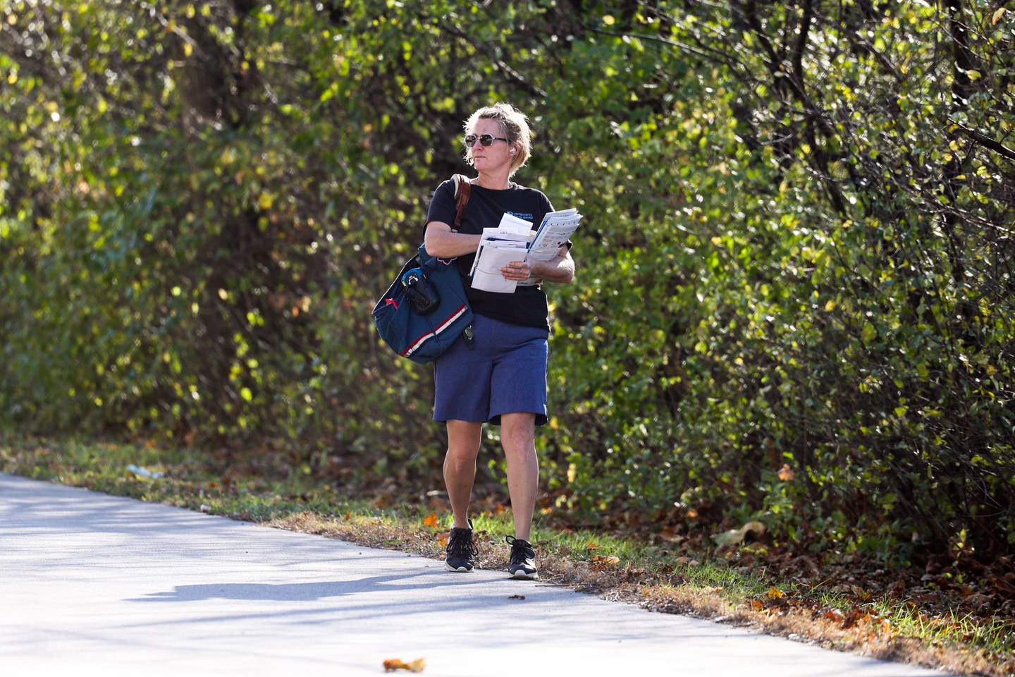 A mail carrier does her rounds along South Park Road wearing short as temperatures reach high 70’s on Thursday, November 10th in Joliet.