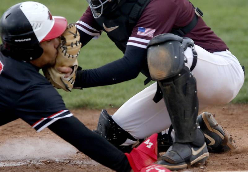 Huntley's Diego Herrera is tagged out as home plate by Prairie Ridge's Beckett Breseman during a Fox Valley Conference baseball game on Friday, May 1, 2026, at Prairie Ridge High School.