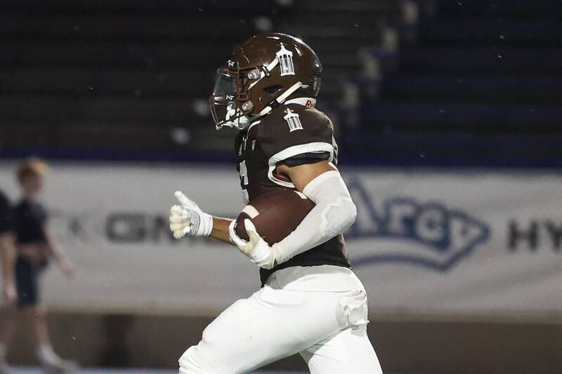 Joliet Catholic’s Preston Coleman breaks away for a touchdown against Iowa City on Friday, August 30, 2024 in Joliet.