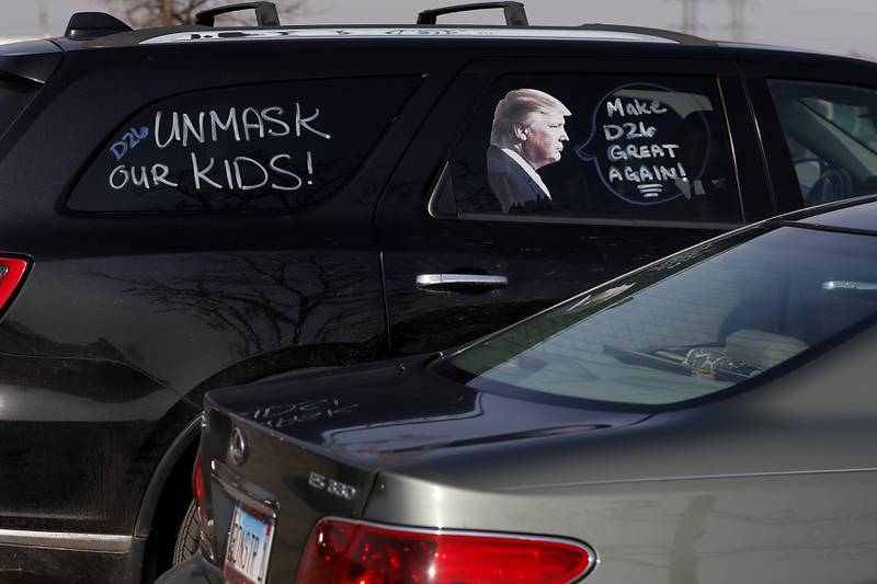 A car in the parking lot at Cary-Grove Park during a Cary School District 26 anti-mask rally Tuesday, Feb. 15, 2022. About 100 people attend the event organized by the Illinois Parents Union Cary.