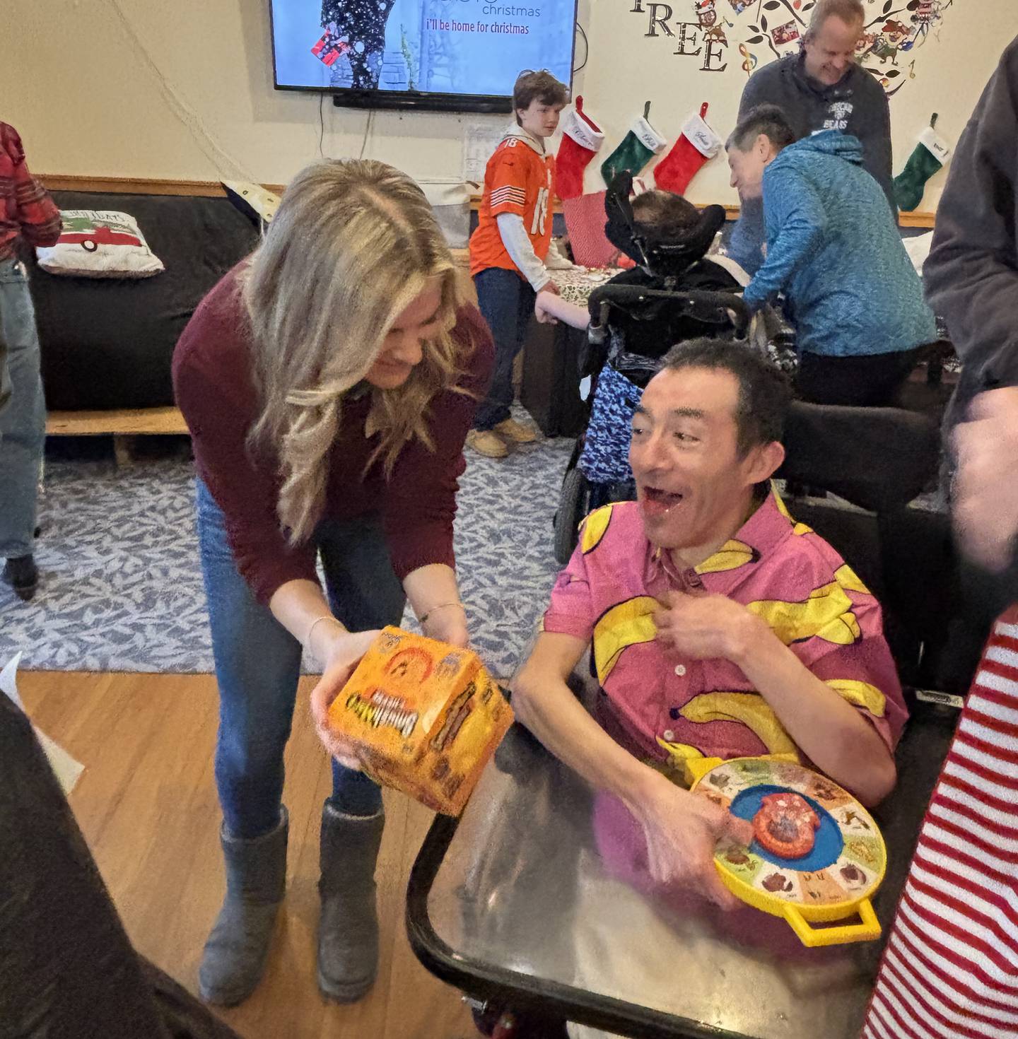Marklund volunteer Devon Brueske shows resident Jesus G. one of his holiday gifts donated through the organization’s giving tree gift drive.