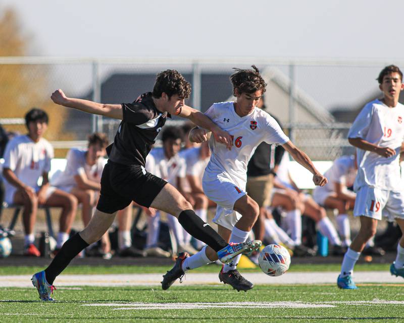 Oswego's Benjamin Sobecki (16) fights off the defense of Wheaton Warrenville South's Marco Gonzales (20) during the Class 3A Plainfield North Regional final game between Oswego and Wheaton Warrenville South. Oct 22, 2022