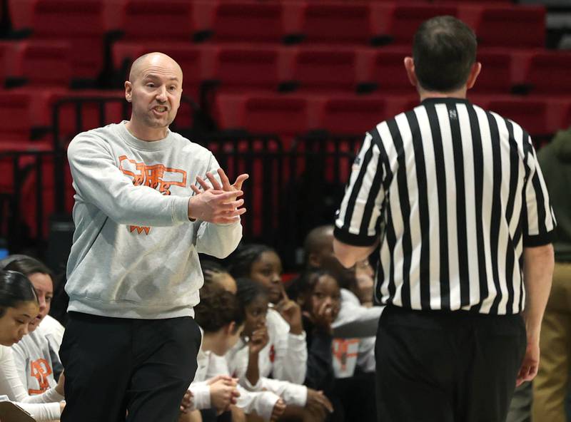 DeKalb head coach Bradley Bjelk talks to an official Friday, Jan. 30, 2026, during their game against Sycamore in the FNBO Challenge in the Convocation Center at Northern Illinois University in DeKalb.