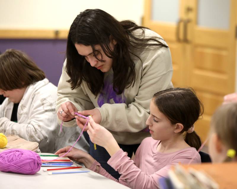 Instructor Karen Perez helps Lillian Sanchez, 11, of Plano with a crochet project during a session of the Knit and Crochet Group at the Plano Community Library District.