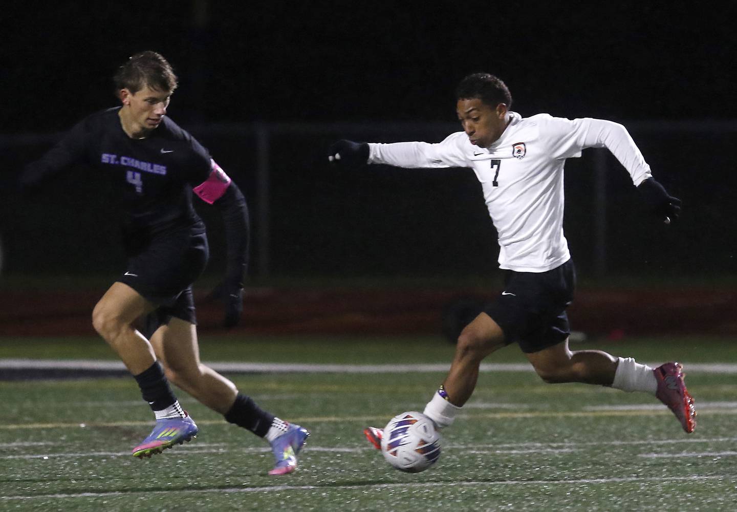 McHenry's Miguel Rondon makes a run against St. Charles North's Ashton Goettel during an IHSA Class 3A Huntley Regional boys soccer semifinal match on Tuesday, Oct. 21, 2025, at Huntley High School.