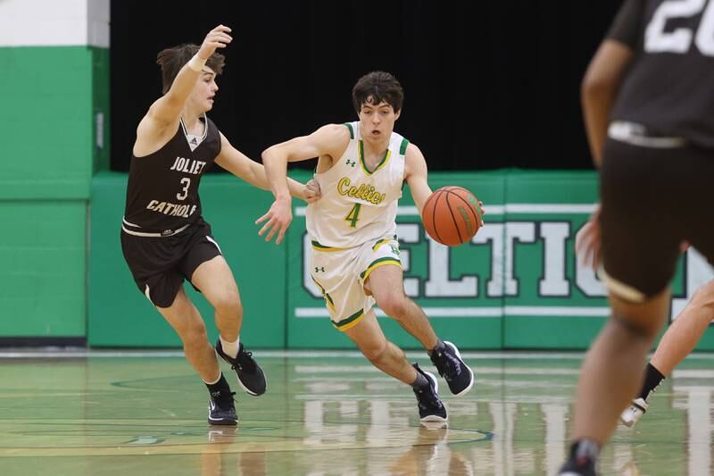 Providence’s Zach Ford drives around Joliet Catholic’s Connor Louthan on Saturday, Dec. 9th, 2023 in New Lenox.