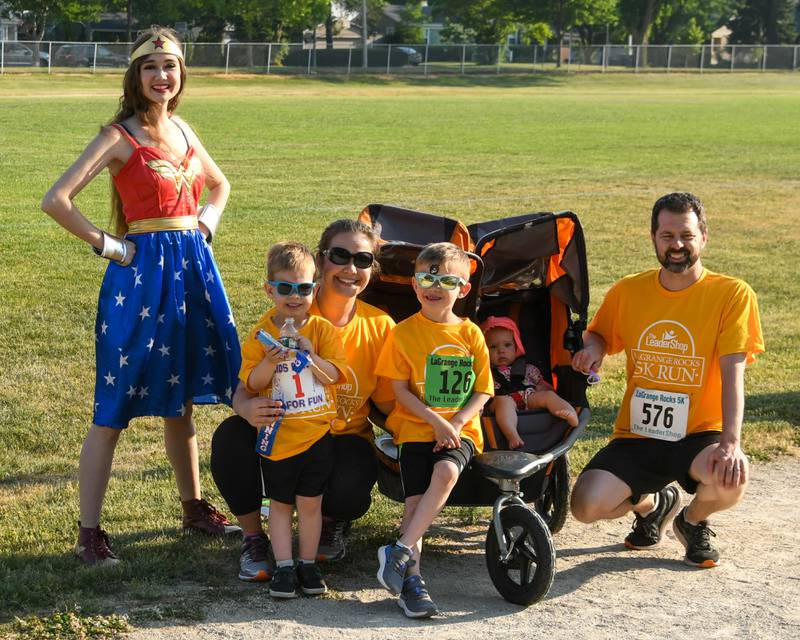 The Hamp family of La Grange pose for a photo with Wonder Woman after completing the 1 lap race during the Leadershop event held in La Grange on Friday June 9, 2023.