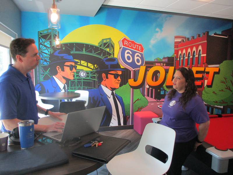 Xiomara Ramos (right), general manager at the new Tru by Hilton in Joliet discusses plans on Wednesday for the hotel opening the next day with Luke Cannon, regional manager for Raymond Management, the company that owns the hotel, in a lobby that features a Joliet mural, games and a snack bar. June 11, 2025