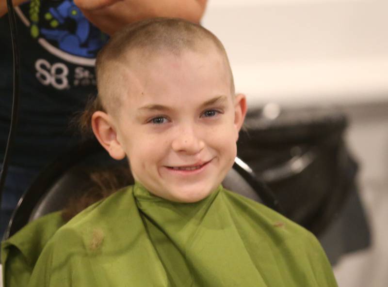 Jake Brown, of Utica, smiles as he has his head shaved during the 18th annual Illinois Valley Emergency Services St. Baldrick's event on Sunday, March 23, 2025 at Senicas Oak Ridge in La Salle.
