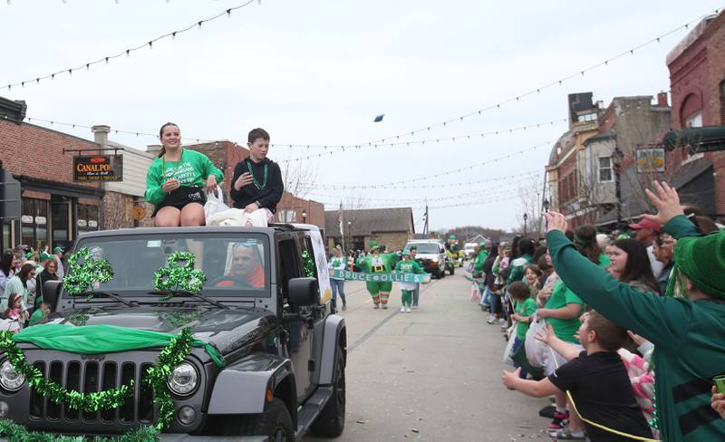Crews with Skoogs Pub & Grill ride in a Jeep during the St. Patrick's Day parade on Saturday, March 15, 2025 downtown Utica.