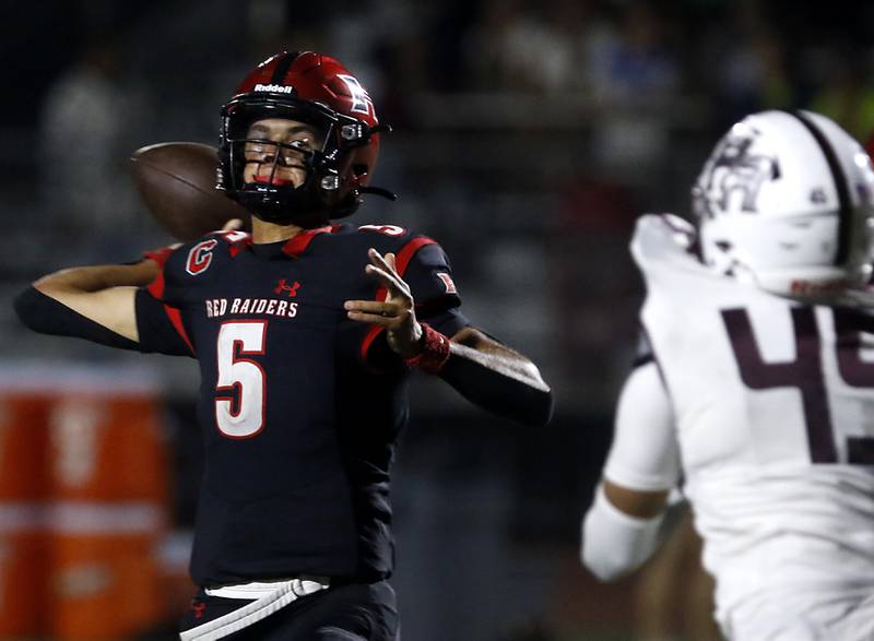 Huntley's Malik Carter throws a pass that was intercepted by Prairie Ridge's Elijah Loeding win the game for Prairie Ridge during a Fox Valley Conference football game on Friday, Oct. 3, 2025, at Huntley High School.