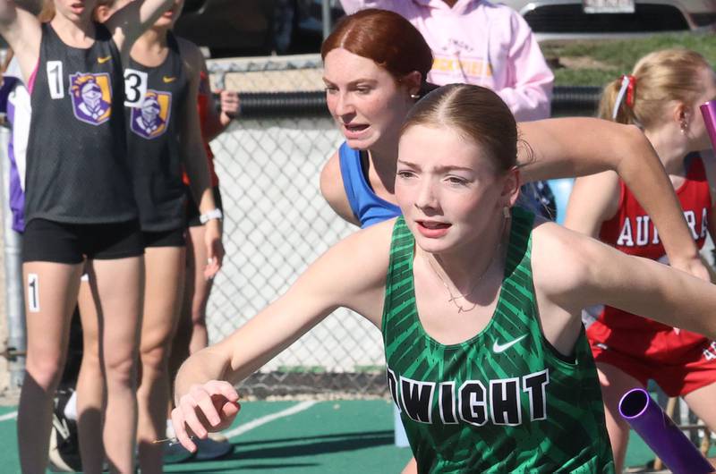 Dwight's Chloe Leithliter and Somonauk's Ella Roberts run the 800 meter relay during the Class 1A Sectional meet on Thursday, May 14, 2026 at Seneca High School.