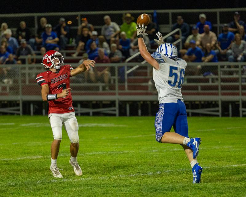 Dylan Glynn (7) of Hall throws ball as Owen Hartman (56) of Princeton attempts to intercept on Friday, Oct. 3, 2025 at Richard Nesti Stadium in Spring Valley.