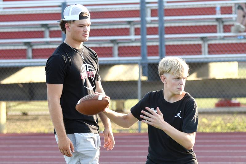 Ethan Kohl, left, a 2024 Bradley-Bourbonnais graduate, watches his brother, Griffin Kohl, a seventh grader at Bourbonnais Upper Grade Center, work during a drill at the Bradley-Bourbonnais quarterback camp Wednesday, July 2, 2025.