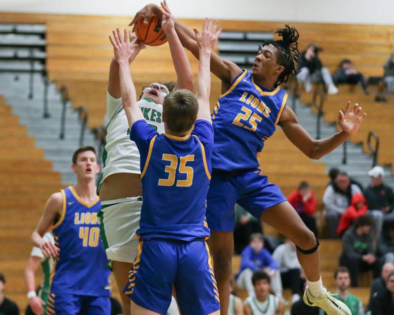 Lyon's Marshaun Russell (25) blocks a shot attempt by York's Costa Kampas (42) during their basketball game between Lyons at York. Jan 10, 2025 in Elmhurst.