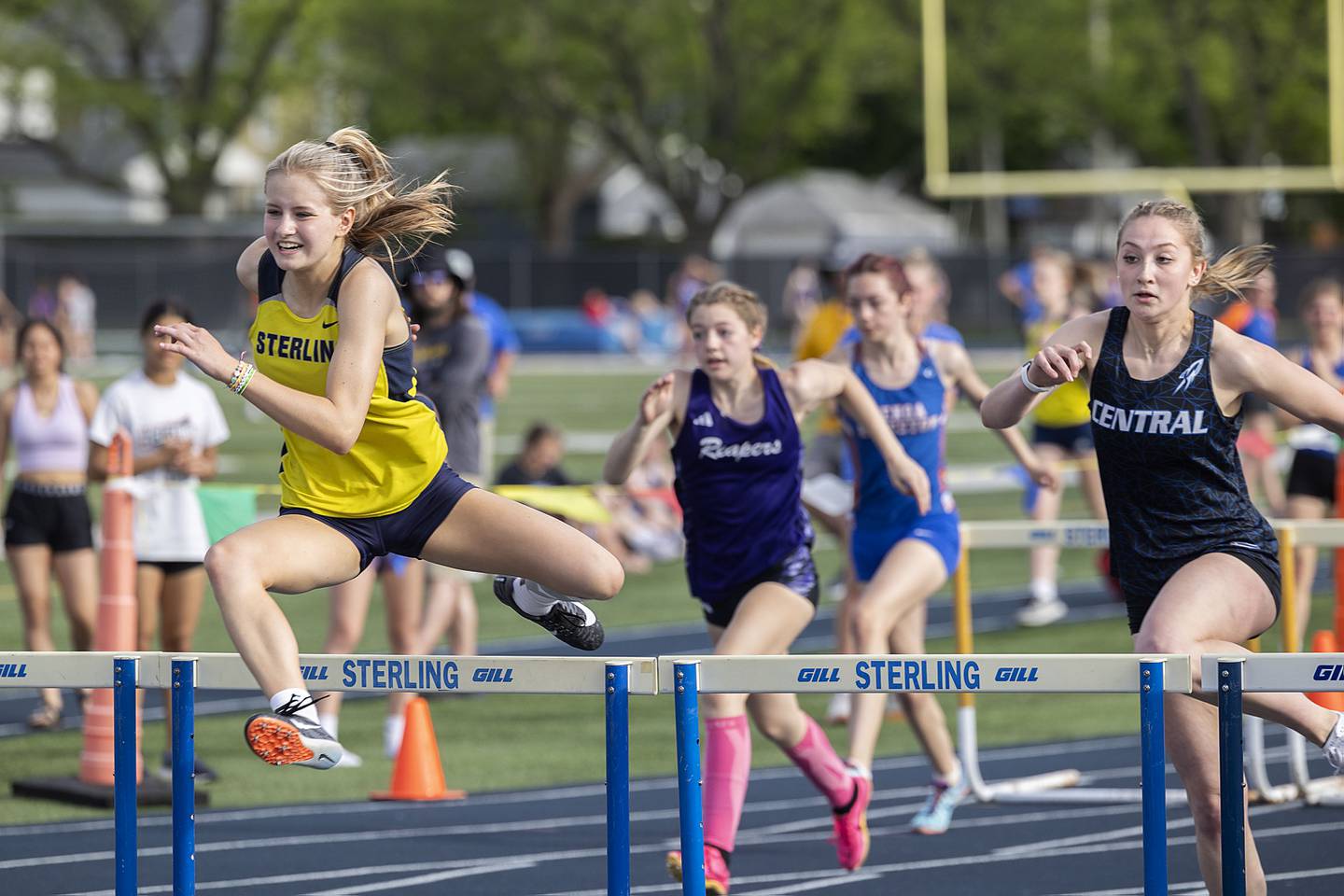 Sterling’s Anna Aulwes clears the final hurdle to win her heat in the 100 hurdles Thursday, May 11, 2023 at the class 2A Sterling girls track sectionals.