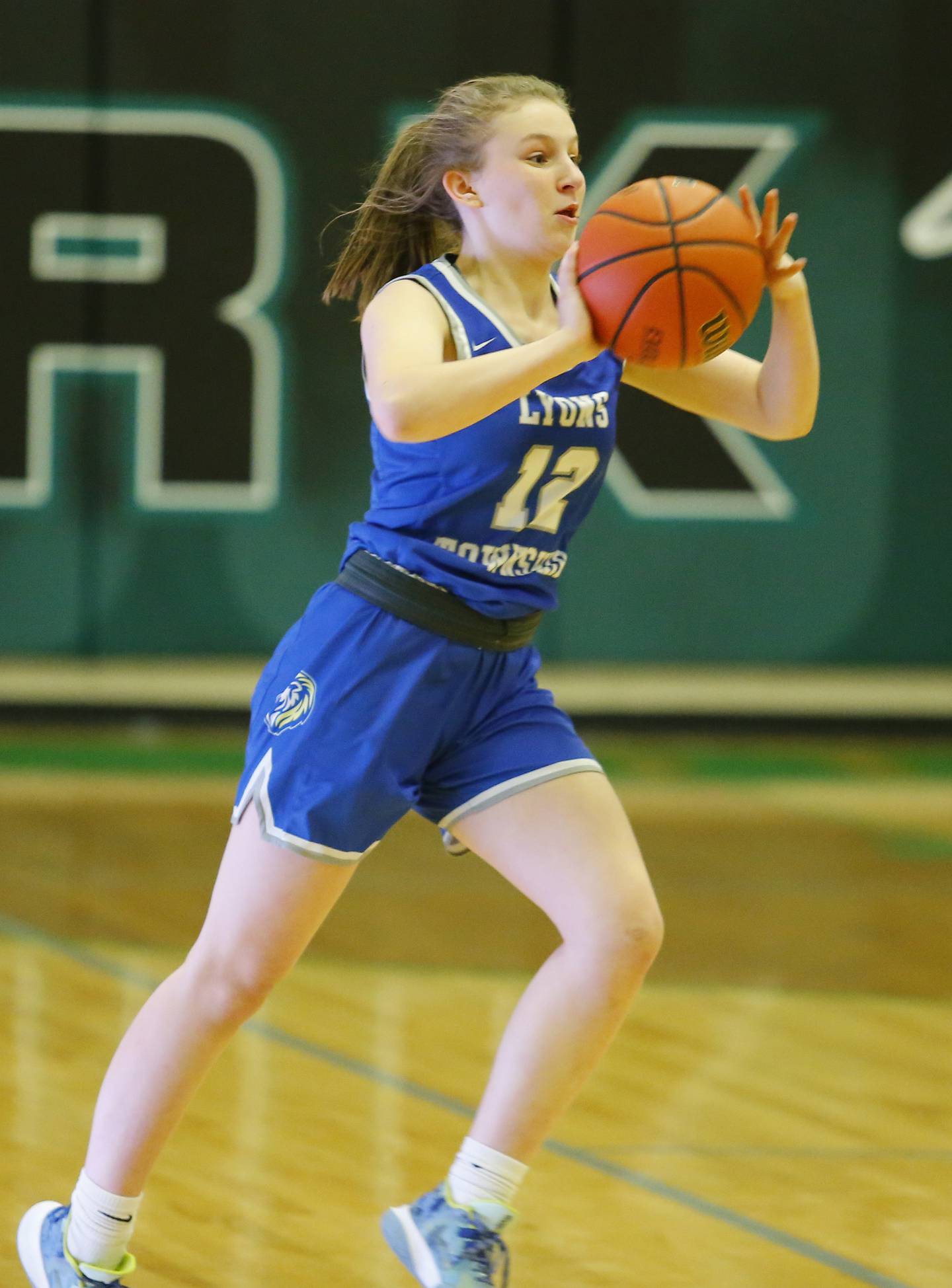 Lyons' Avery Mezan (12) passes during the girls varsity basketball game between Lyons Township and York high schools on Friday, Dec. 16, 2022 in Elmhurst, IL.