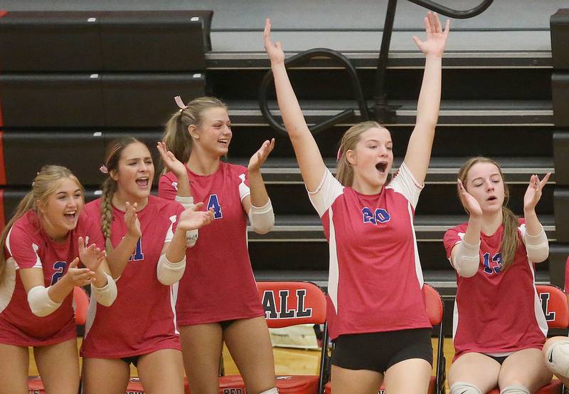 Members of the Princeton volleyball team react after winning the first set against Hall on Thursday, Oct. 9, 2025 at Hall High School.