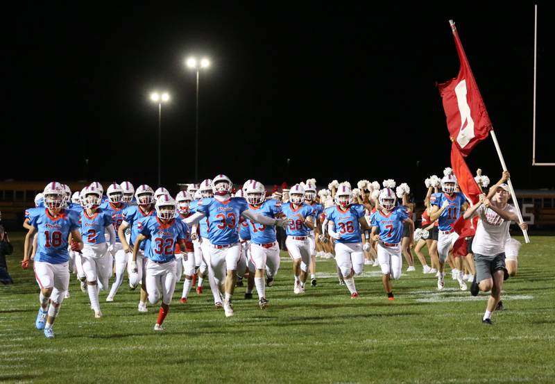The Ottawa Pirate football team runs onto King Field for the Homecoming game against L-P on Friday, Oct. 4, 2024 at Ottawa High School.