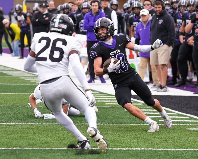Downers Grove North's Oliver Thulin (10) zig zags to gain extra yards before being brought down by Fenwick's Josh Morgan (26) during the second week of the class 3A game held on Nov. 9, 2024, held at Downers Grove North.
