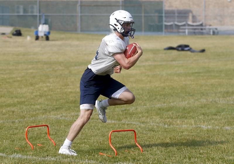 Cary-Grove’s Jack Rocen runs a drill during football practice Thursday, June 29, 2022, at Cary-Grove High School in Cary.