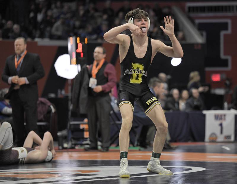 Batavia’s Kai Enos reacts for the crowd after defeating Morris’ Paxton Valentine’s in the Class 120-pound bout at the boys IHSA wrestling finals at State Farm Center in Champaign on Saturday, Feb. 21, 2026.