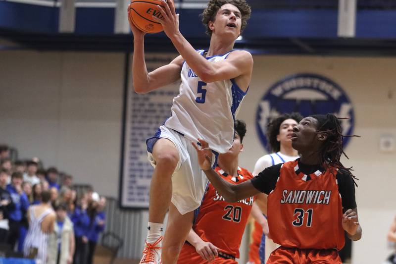 Woodstock’s Max Beard, left, gets past Sandwich’s EJ Treptow in varsity boys basketball on Tuesday, Feb. 11, 2025, at  Woodstock High School in Woodstock.