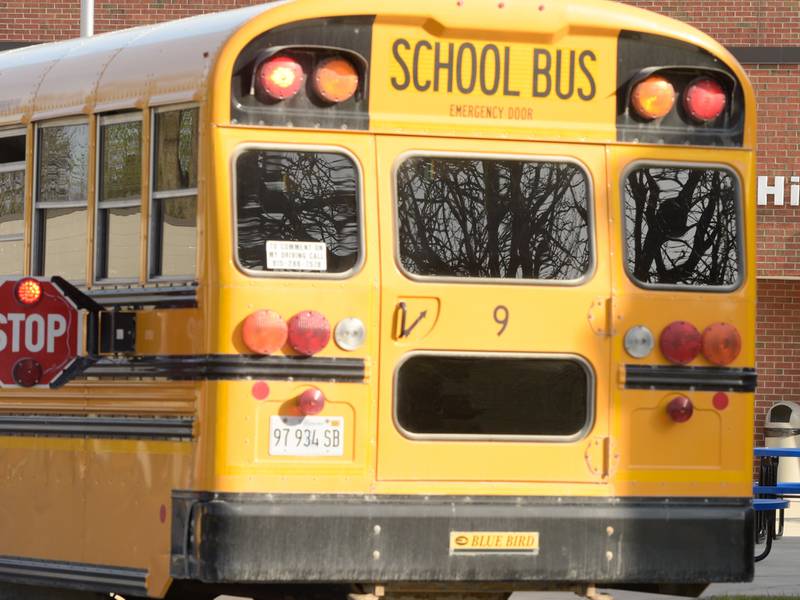 Students exit a school bus as they enter Hinckley-Big Rock Middle School that is part of School District 429 on Tuesday, April 27, 2021.