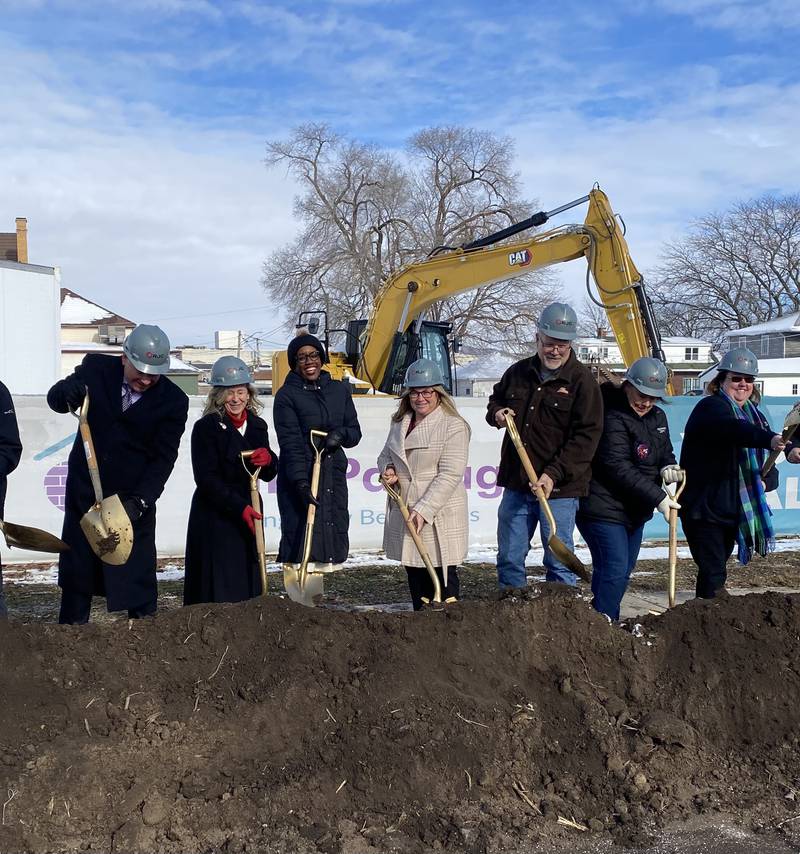 Officials including (from left) CEO of Ringland-Johnson Construction Brent Johnson, Christine Kaline of Safe Passage Inc., U.S. Rep. Lauren Underwood, D-Naperville, and Rebecca Versluys, executive director of Safe Passage, shovel the first dirt on Friday, Dec. 5, 2025, to begin construction of the crisis shelter's new building at 217 S. Franklin St., in DeKalb.