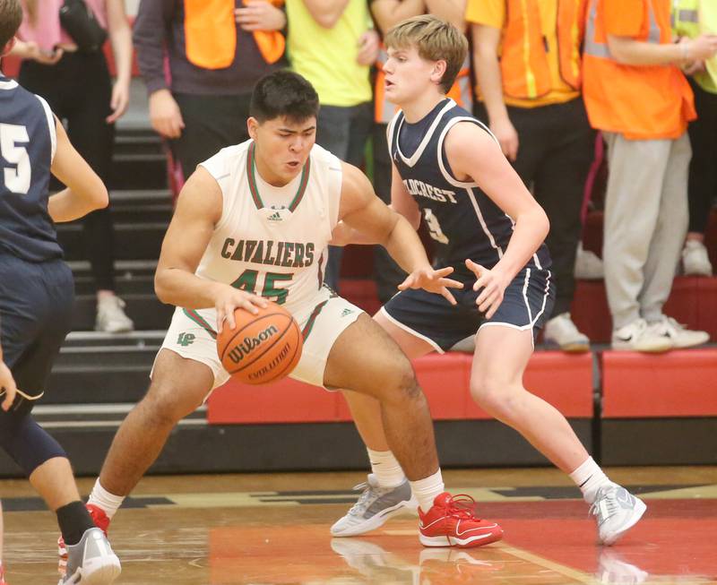 L-P's Andy Medina attemps to work his way into the lane while being guarded by Fieldcrest's Edmone Lorton during the 49th annual Colmone Classic on Friday, Dec. 8, 2023 at Hall High School.