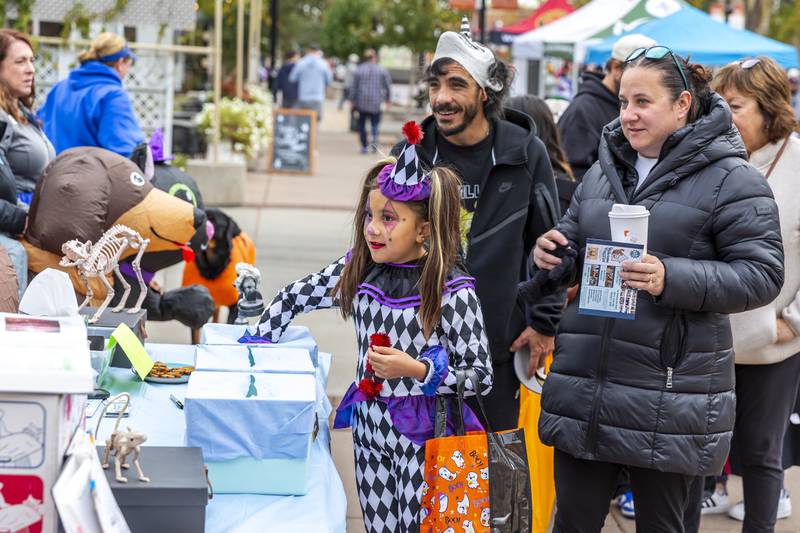 A trick or treater goes in for candy at the Plainfield Spooktacular Trick-or-treating event Saturday Oct 25, 2025 in Plainfield.