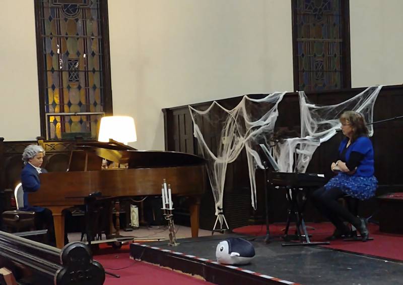 Ben Kuiper (left), dressed as Beethoven for Halloween, performs "Pumpkin Boogie" on the piano Sunday evening during the Scary Organ and Piano Concert at Open Table United Church of Christ in Ottawa. Students and colleagues of Anne Badger (right) performed eerie music in celebration of Halloween.