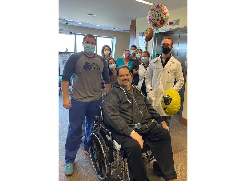 George Fushi of Frankfort spent nearly four months recovering from COVID-19 before finally receiving a celebratory sendoff from his caregiving team at Silver Cross Hospital in New Lenox. Fushi's son Jett is by his side.