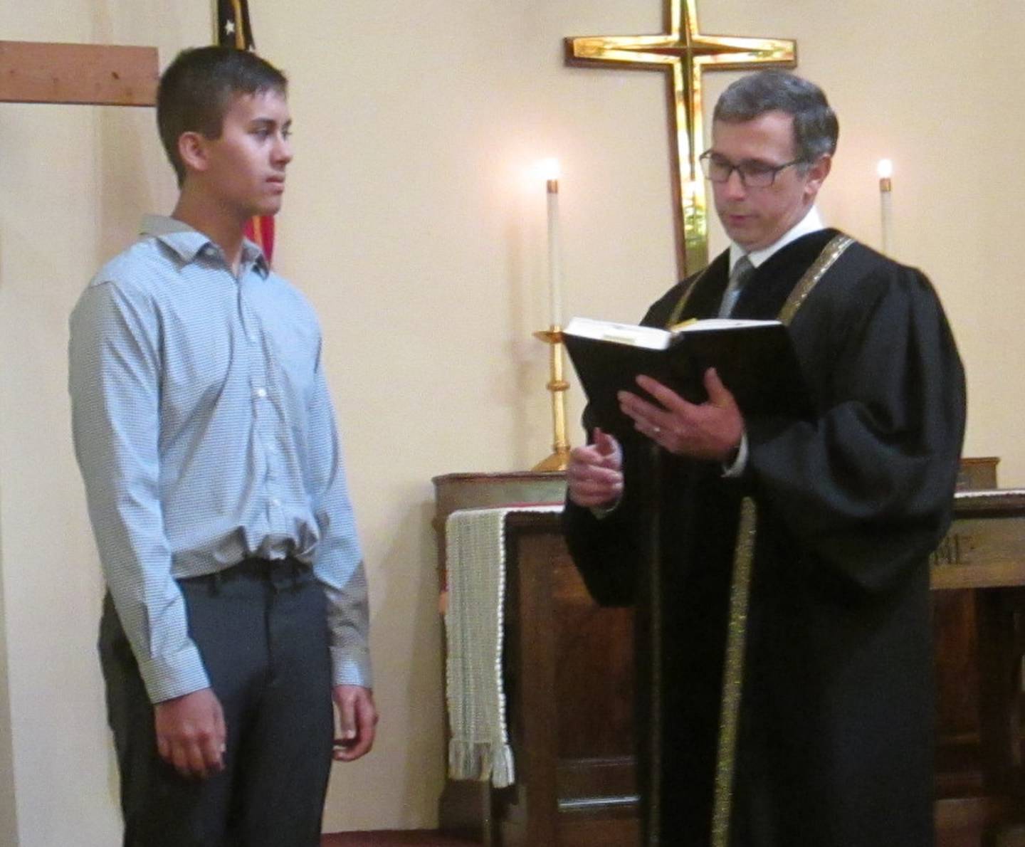 Pictured is United Methodist Church of Plano confirmand Braden with Pastor Steve offering a prayer.