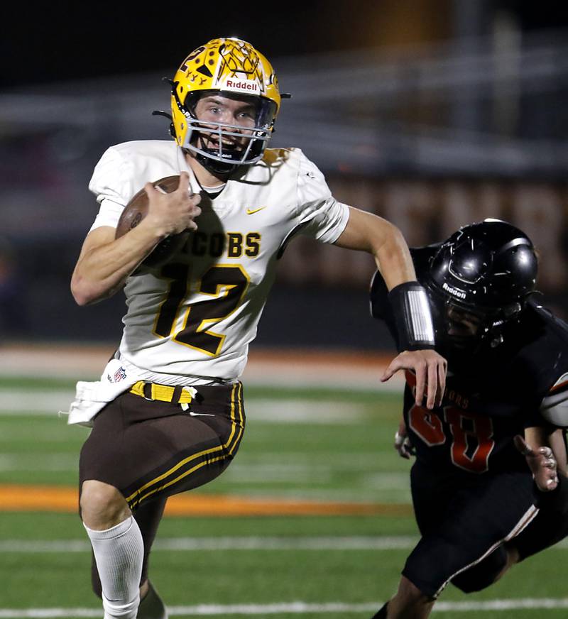 Jacobs' Connor Goehring breaks away from McHenry's Elijah Guardyak to run for a touchdown during a Fox Valley Conference football game on Friday, Oct. 18, 2024, at McCracken Field in McHenry.