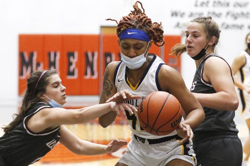 Prairie Ridge's Grace Koeppen, left, and Kelly Gende, right, defend against Round Lake's Amari Cole during their Northern Illinois Girls Holiday Tournament basketball game at McHenry High School Upper Campus on Tuesday, Dec. 21, 2021 in McHenry.