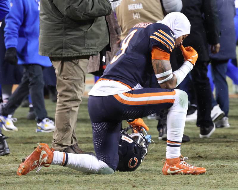 Chicago Bears safety Jaquan Brisker kneels with his head down after their overtime loss to the Los Angeles Rams Sunday, Jan. 18, 2026, in the NFC divisional playoff matchup at Soldier Field in Chicago.