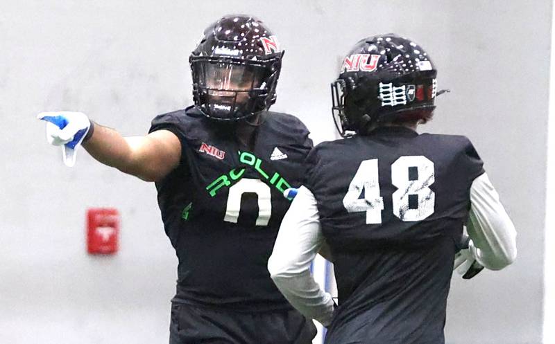 Northern Illinois linebackers Tyler Jackson (left) and Nick Alvarado talk during the teams first spring practice Wednesday, March 22, 2023, in the Chessick Practice Center at Northern Illinois University in DeKalb.