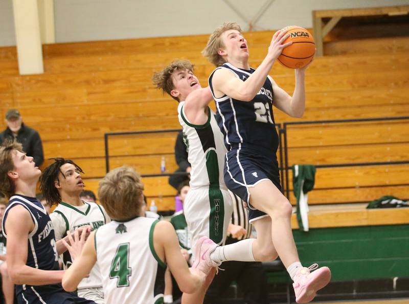 Fieldcrest's Jordan Heider eyes the hoop after working around Midland's Landon McFadden on Wednesday, Feb. 19, 2025 at Midland High School.
