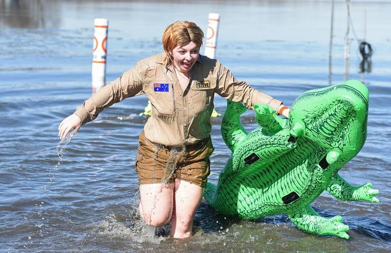 Jessica Marvin of Mundelein, dressed as Steve Irwin, hurriedly gets out of the water Sunday during the Fox Lake Polar Plunge for Special Olympics at Nippersink Lake.