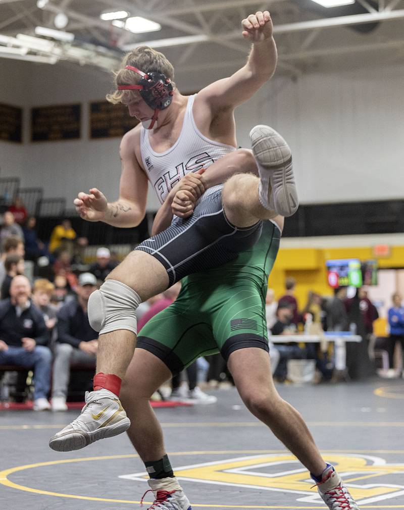 Alleman’s Jordan Thompson lifts Fulton’s Mason Kuebel in the 175 pound finals Saturday, Jan. 31, 2026, during the Class 1A Wrestling Regionals at Riverdale High School. Thompson won 10-3.