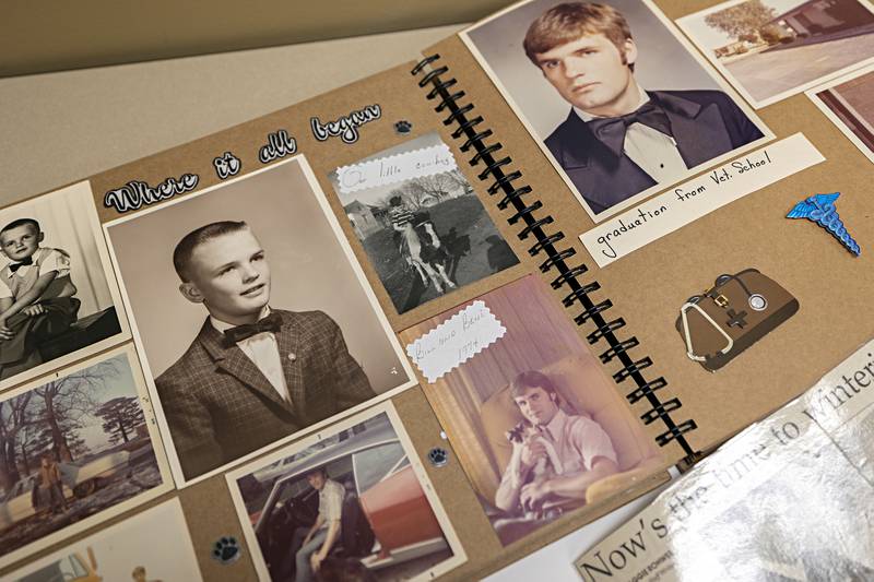 A book of pictures and memories sit on a table displaying Dr. Kuhfus through the years Thursday, Dec. 28, 2023.