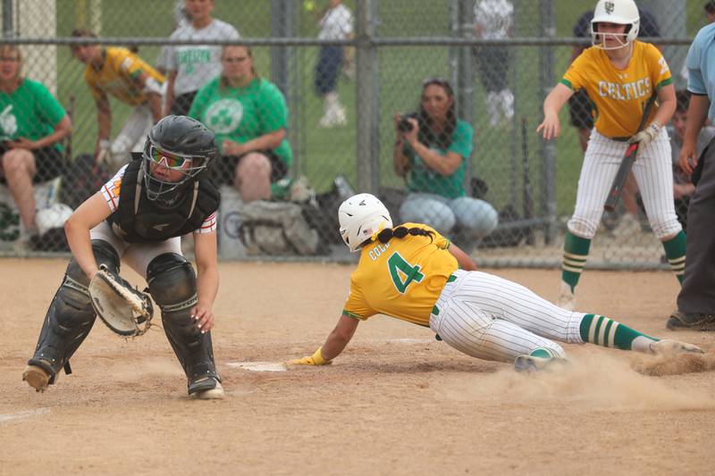 Angelina Cole (4) of Providence successfully slides into home base whilst Lilia Flores (2) of Tinley Park attempts to tag her out on Tuesday, June 3, 2025 at Ottawa High School in Ottawa.