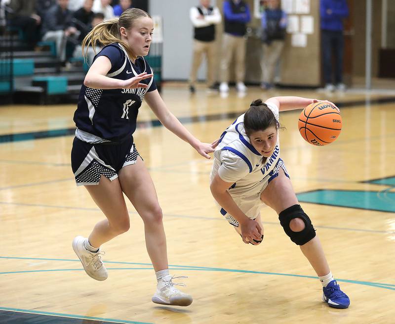 Geneva's Keira McCann (right) tries to drive the lane against St. Viator's Kalin McCrea during the IHSA Class 3A Woodstock North Supersectional girls basketball game on Monday, March 2, 2026, at Woodstock North High School.