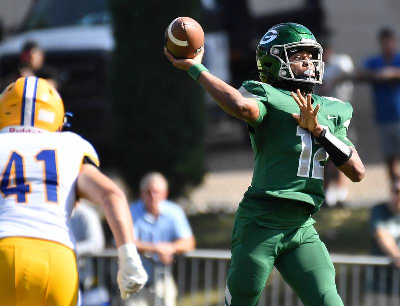 Glenbard West quarterback AJ Rayford fires a long touchdown pass to Chase Cavan during a game against Lyons Township on September 27, 2025 at Glenbard West High School in Glen Ellyn.